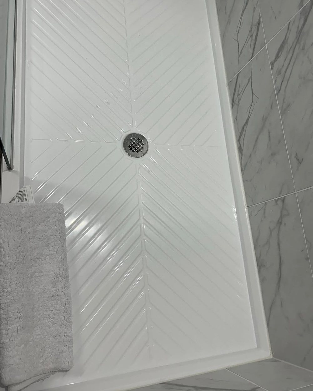 A spotless chevron shower pan polished by BTI Clean